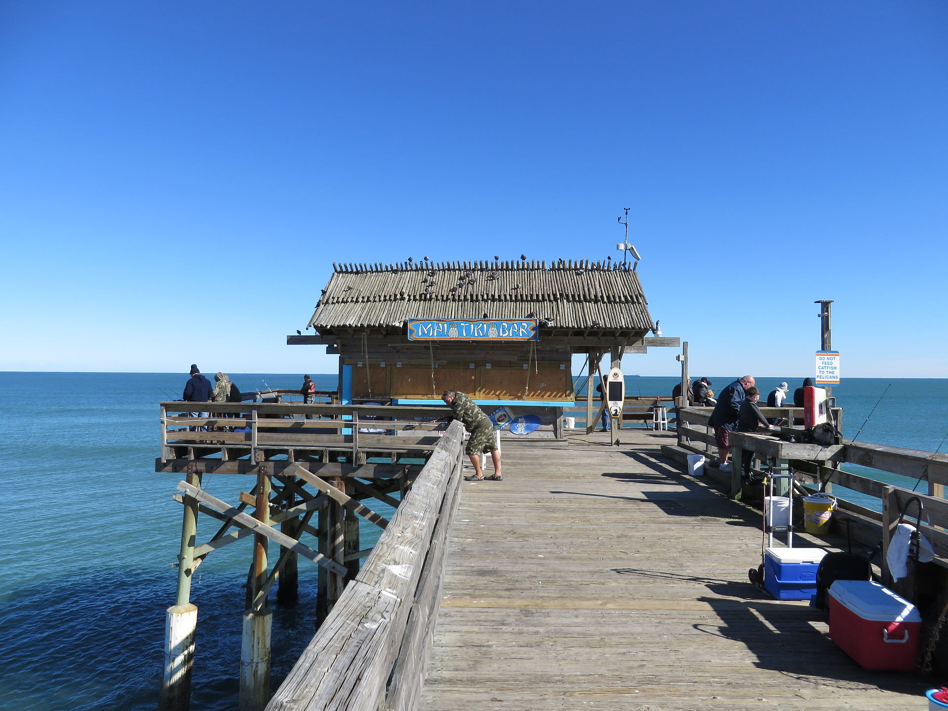 Aerial photograph of the Cocoa Beach Pier, an 800-foot wooden pier with restaurants and shops along its length.