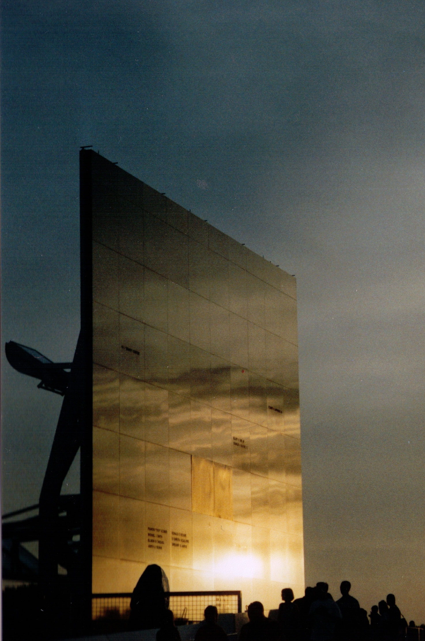 The Space Mirror Memorial at Kennedy Space Center, a 70-foot-tall polished black granite mirror engraved with the names of fallen astronauts.